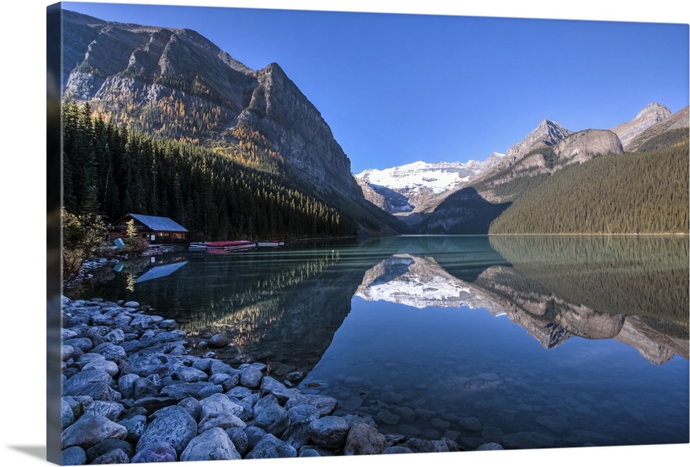 View of Lake Louise and the boathouse with reflection and shadow at the early morning.