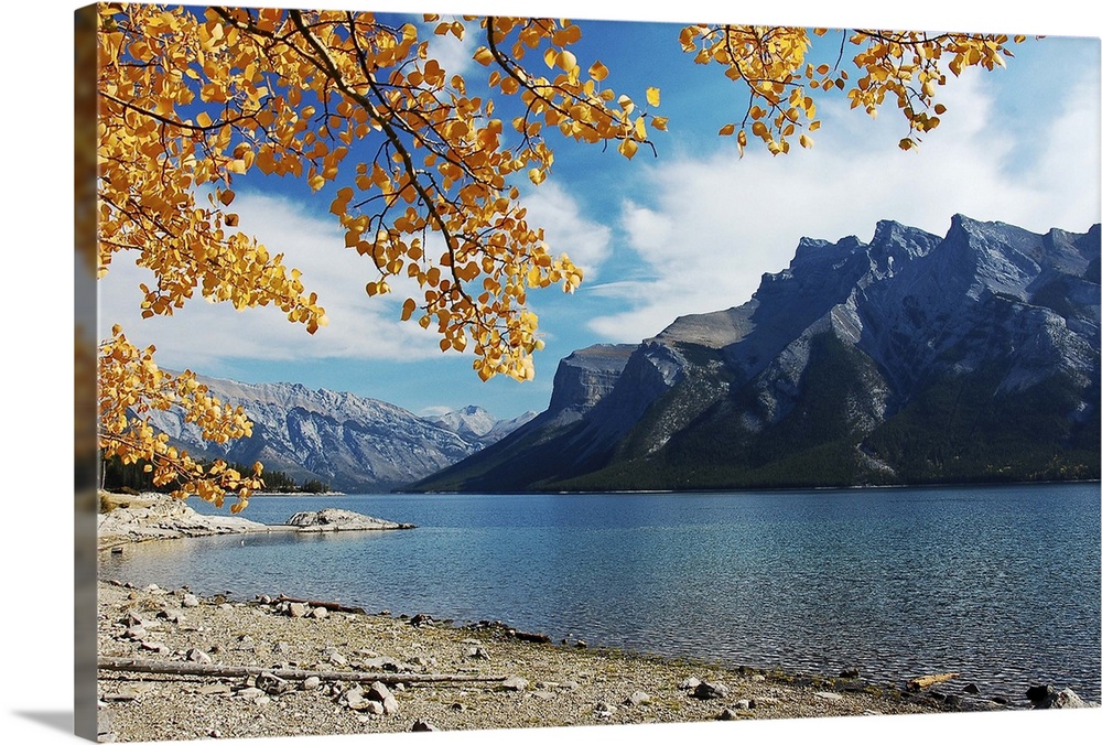 Lake at canadian rocky mountains, framed with autumn leaves, Canada.