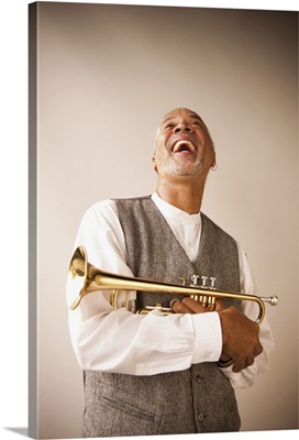 Laughing musician holding trumpet