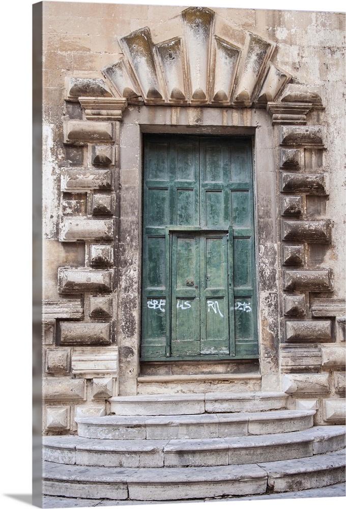 Old Green Door with decorative stone arch and stairs  in Lecce Italy, Lecce is a historic city of 95,200 inhabitants in so...