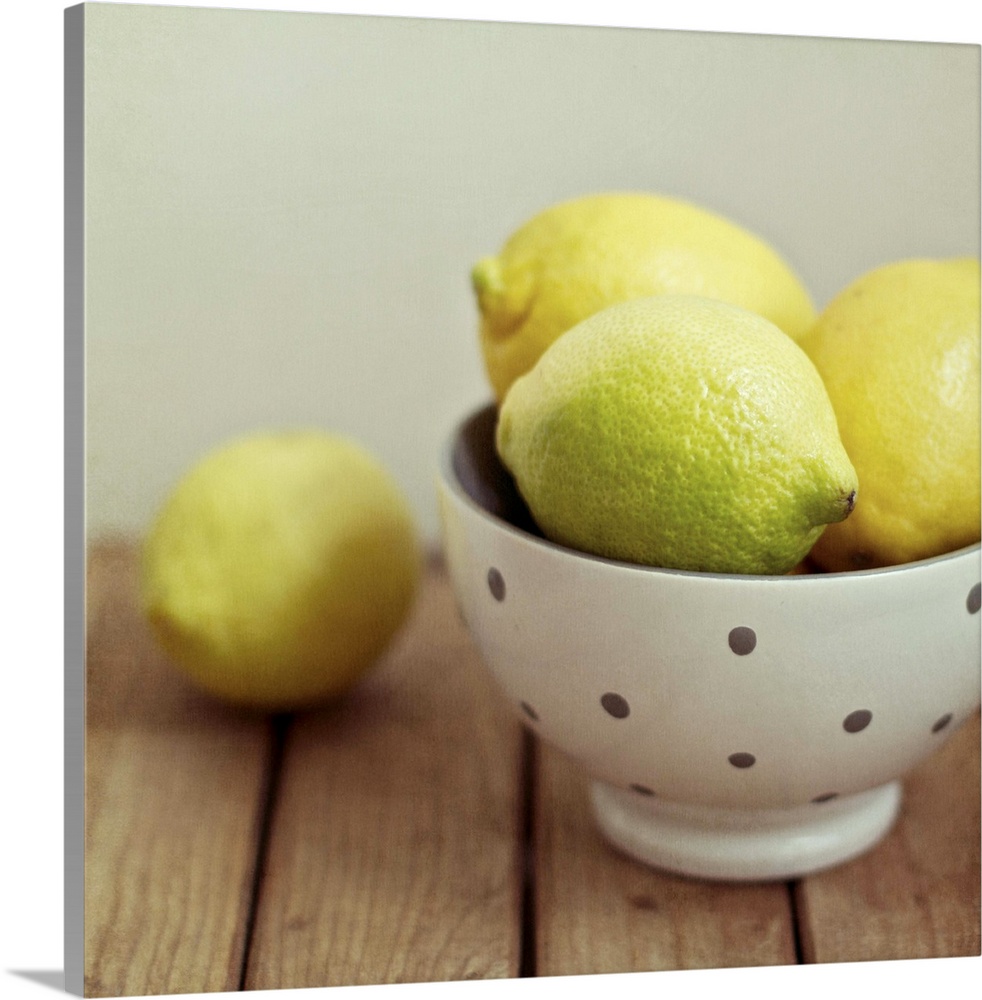 Lemons in bowl on table.