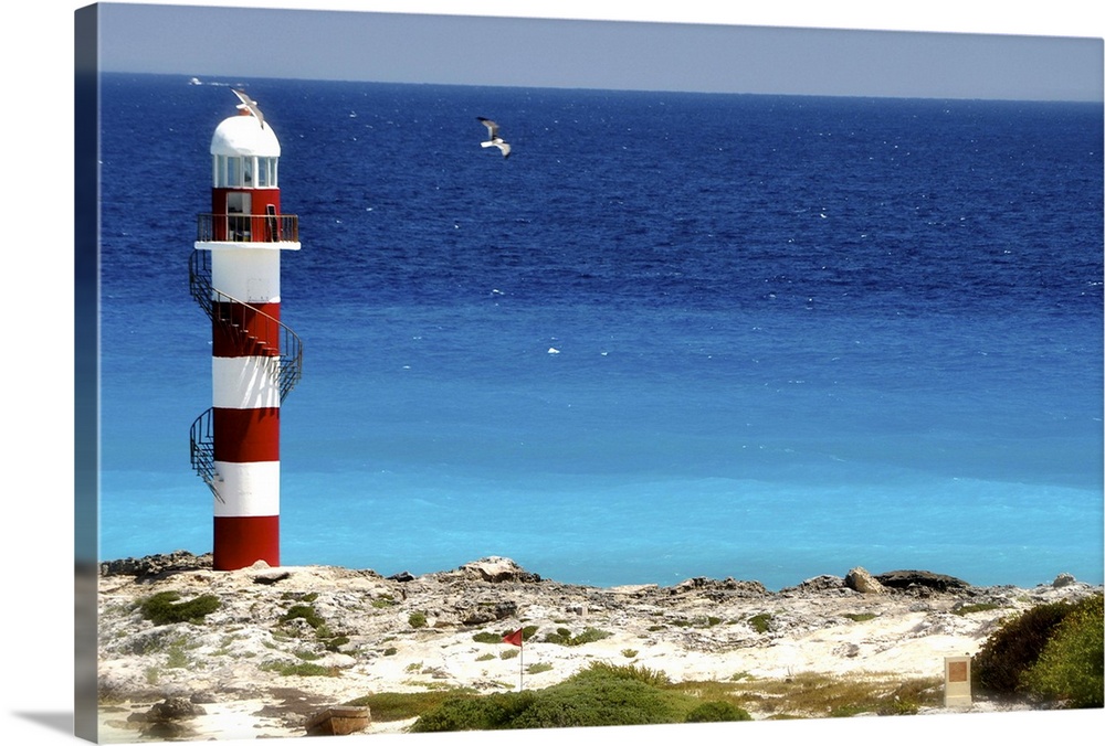Lighthouse against beach in Cancun, Mexico.