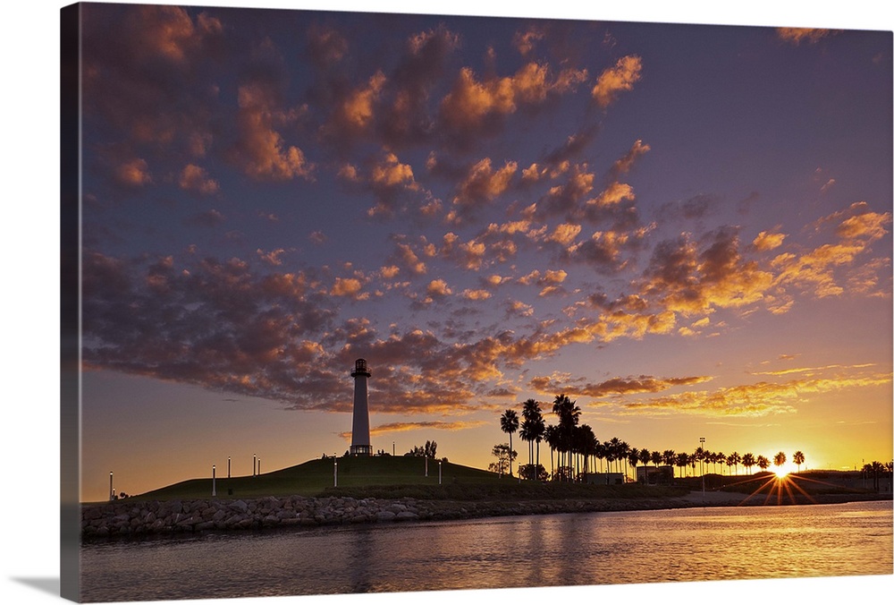 Long Beach lighthouse just as the sun is setting over the harbor.