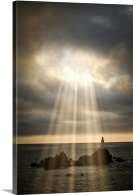 Lighthouse under stormy sky with sundays