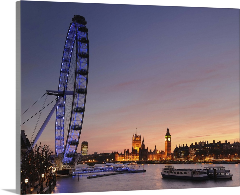 View along The River Thames with the Millennium Wheel (London Eye) and Houses of Parliament at sunset. London, England, UK.