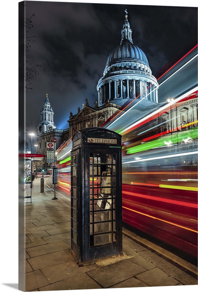 London's iconic telephone box, the trailing lights of its famous  double decker bus with St Paul's cathedral in the backgr...