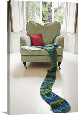 Long knitted scarf on chair