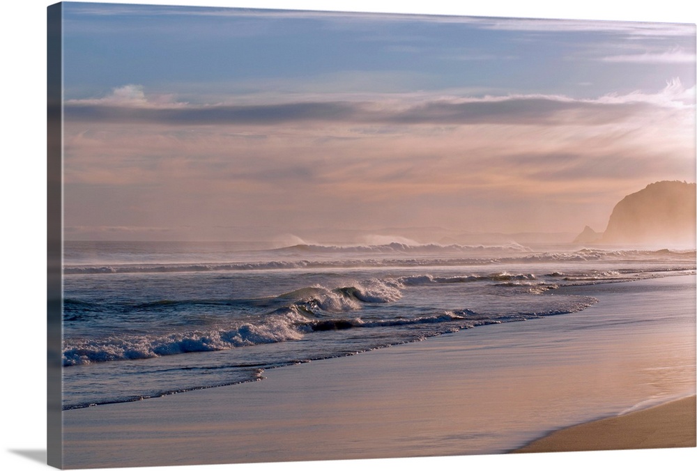 Horizontal photograph on large canvas of waves crashing into the shoreline at St. Kilda, Dunedin.  The sun is setting and ...