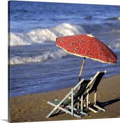 Lounge chairs under a beach umbrella