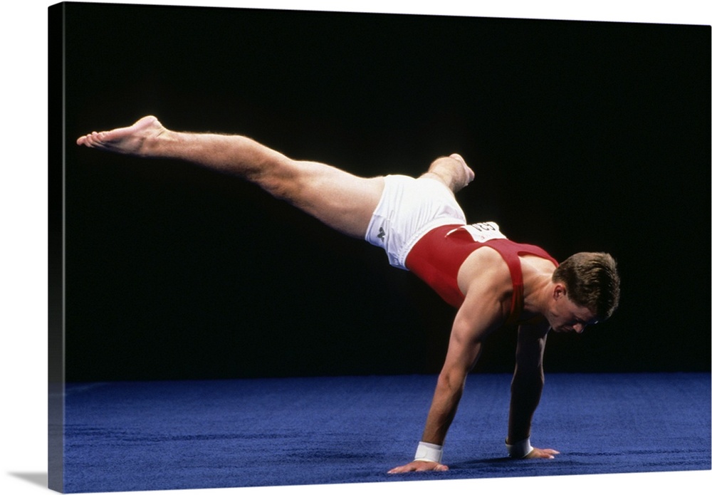 Male gymnast peforming a routine in the floor exercise