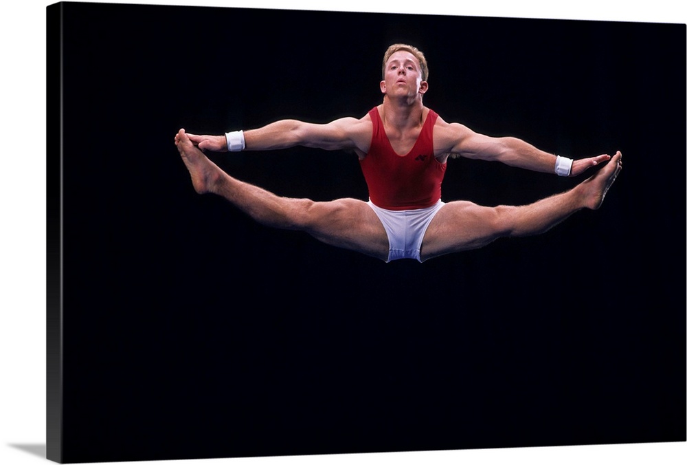 Male gymnast performing on the floor exercise