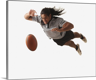 Male rugby player diving for ball