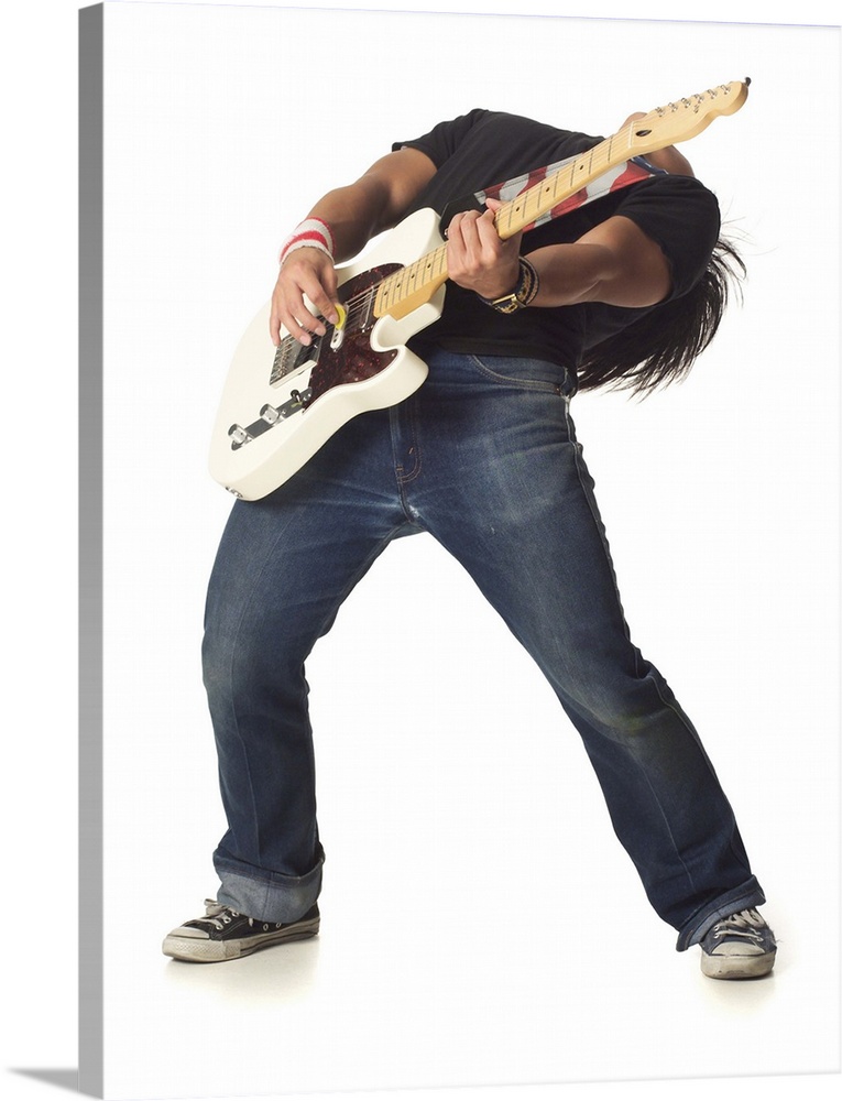 an asian male teen in jeans and a black shirt leans back while playing an electric guitar