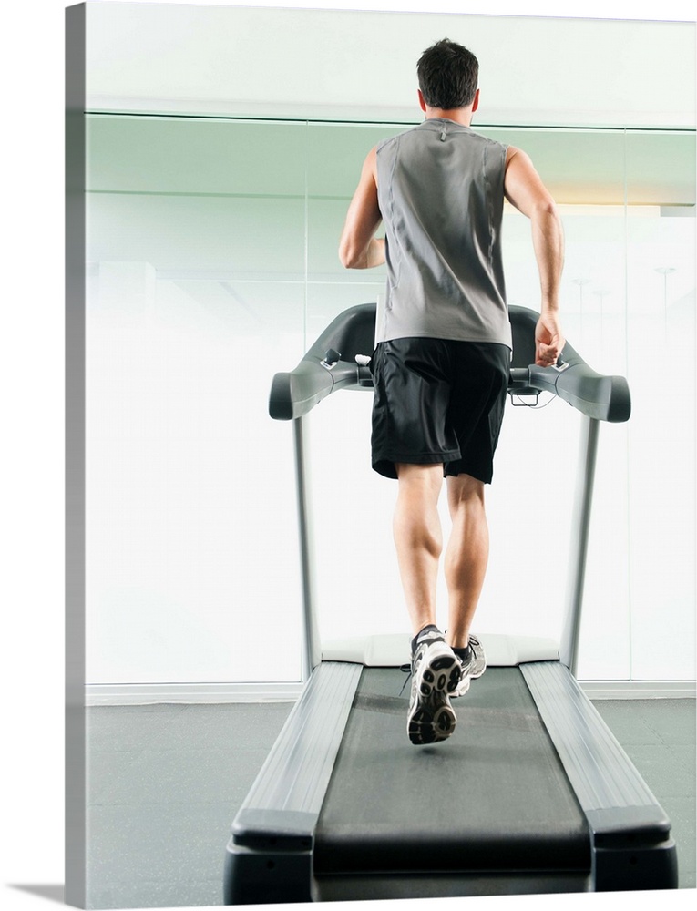 Mixed race man running on treadmill