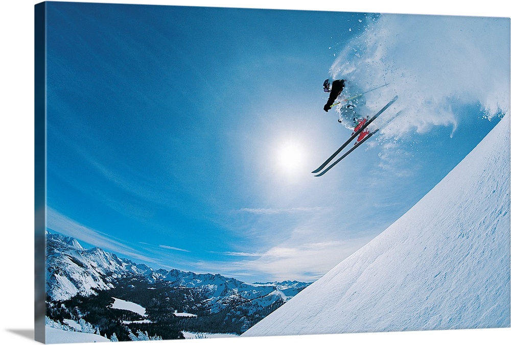 Horizontal, photograph on large canvas of a skier making a jump down an angled slope, in mid-air, heading directly into a ...