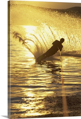 Man water skiing at dusk