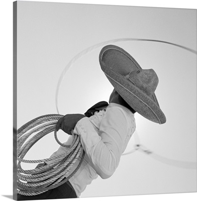 Man wearing hat and holding lasso