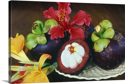 Mangosteen fruit with tropical flowers