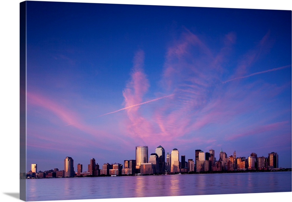 USA, New York, New York City, Setting sun lights clouds above Manhattan skyline, viewed from New Jersey waterfront