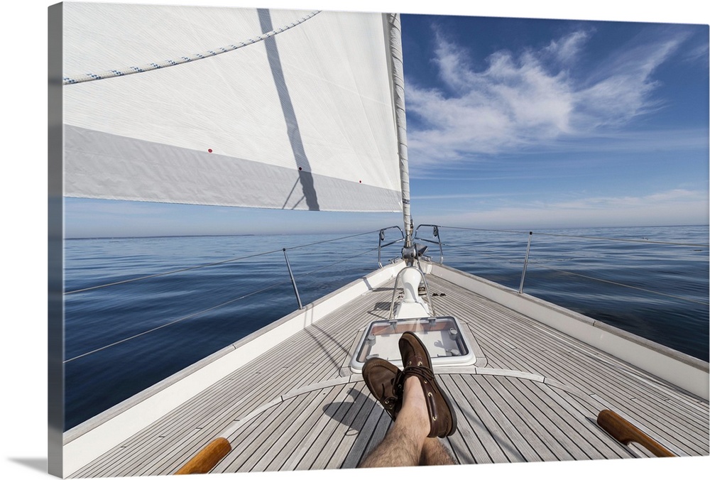 Man's feet crossed on 62 ft sailboat