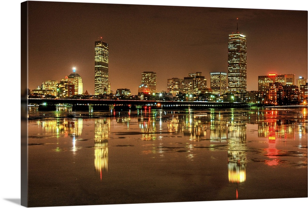 Massachusetts Avenue Bridge and Boston skyline with reflection in Charles river at night in Cambridge, Massachusetts.