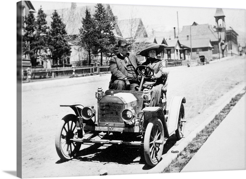 Couple pose in their early Brush Motor Car Company automobile on a Colorado street in the early 20th century.