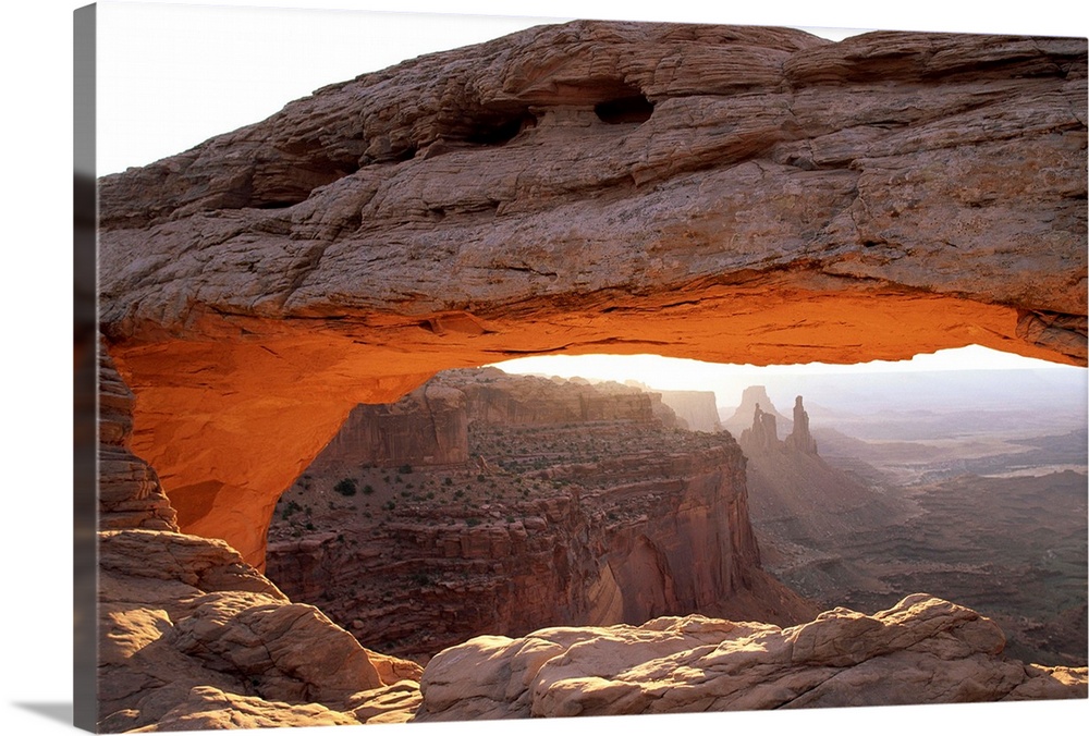 Sunrise lights the Mesa Arch at Canyonlands National Park in Utah.