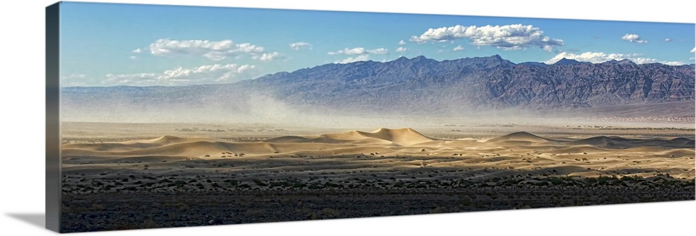 Late afternoon wind storm blows across Mesquite sand dunes in death Valley.