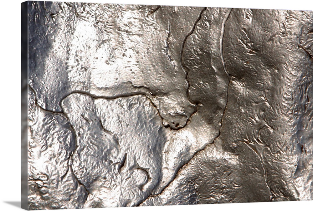Abstract artwork of a metallic silver object that has been photographed close up.