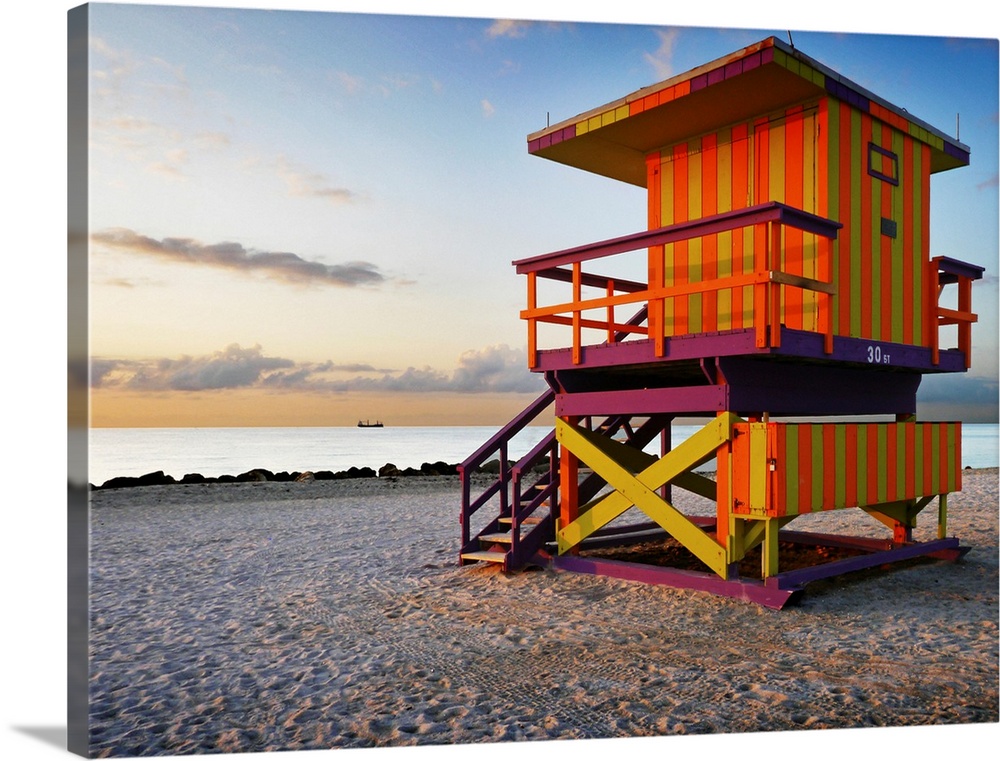 Colorful Miami beach lifeguard station at sunrise with an empty beach.