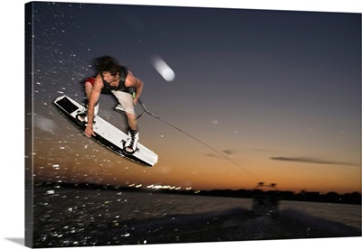 Midair wakeboarder at sunset