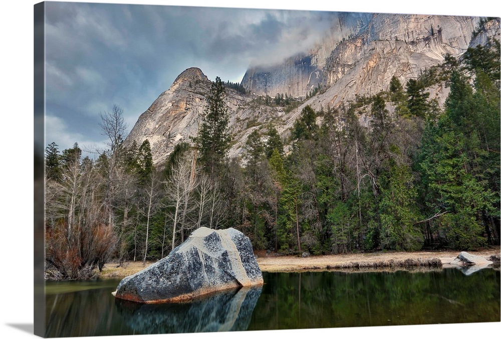 Mirror Lake lies still under Half Dome with evening storm clouds, Yosemite National Park, California, USA.