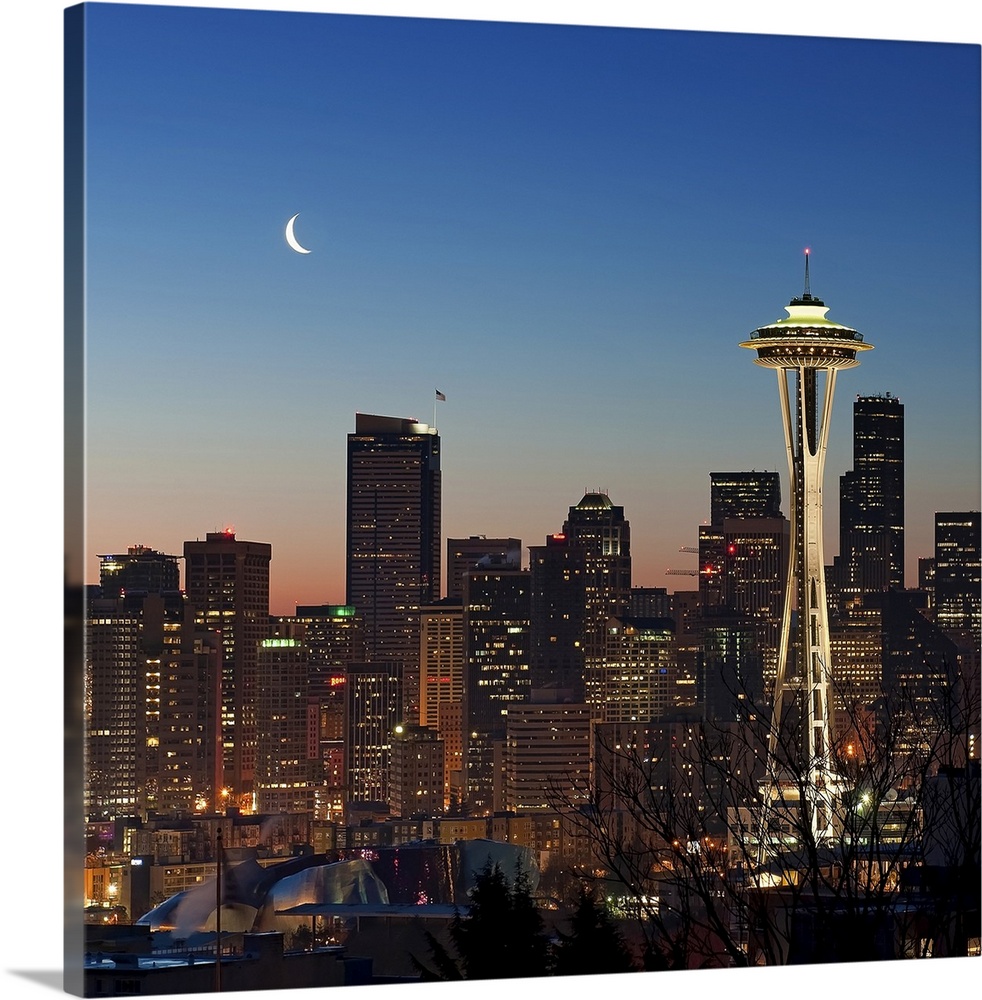 This photograph taken at twilight shows the glowing city skyline available as square shaped wall art.
