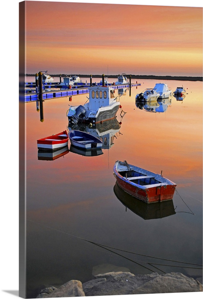 Moored boats on sea at sunset.