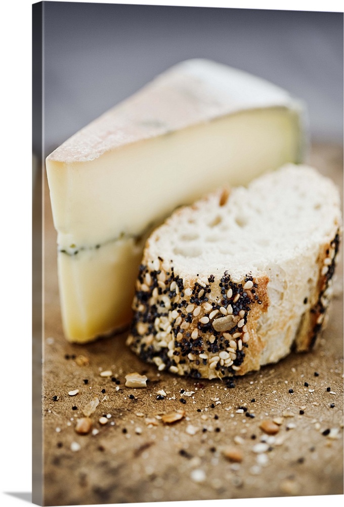 Morbier cheese on a board with seeded bread.