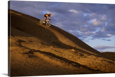Mountain biker descending Slickrock Trail , Moab , UT