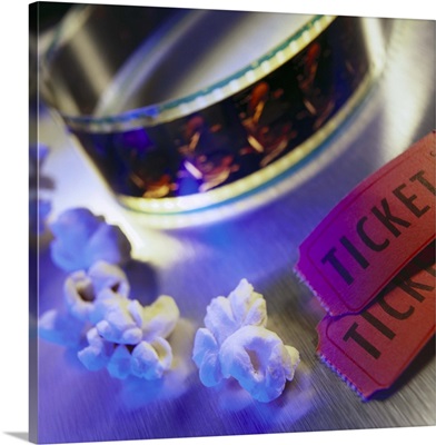 Movie tickets with film strip and popcorn