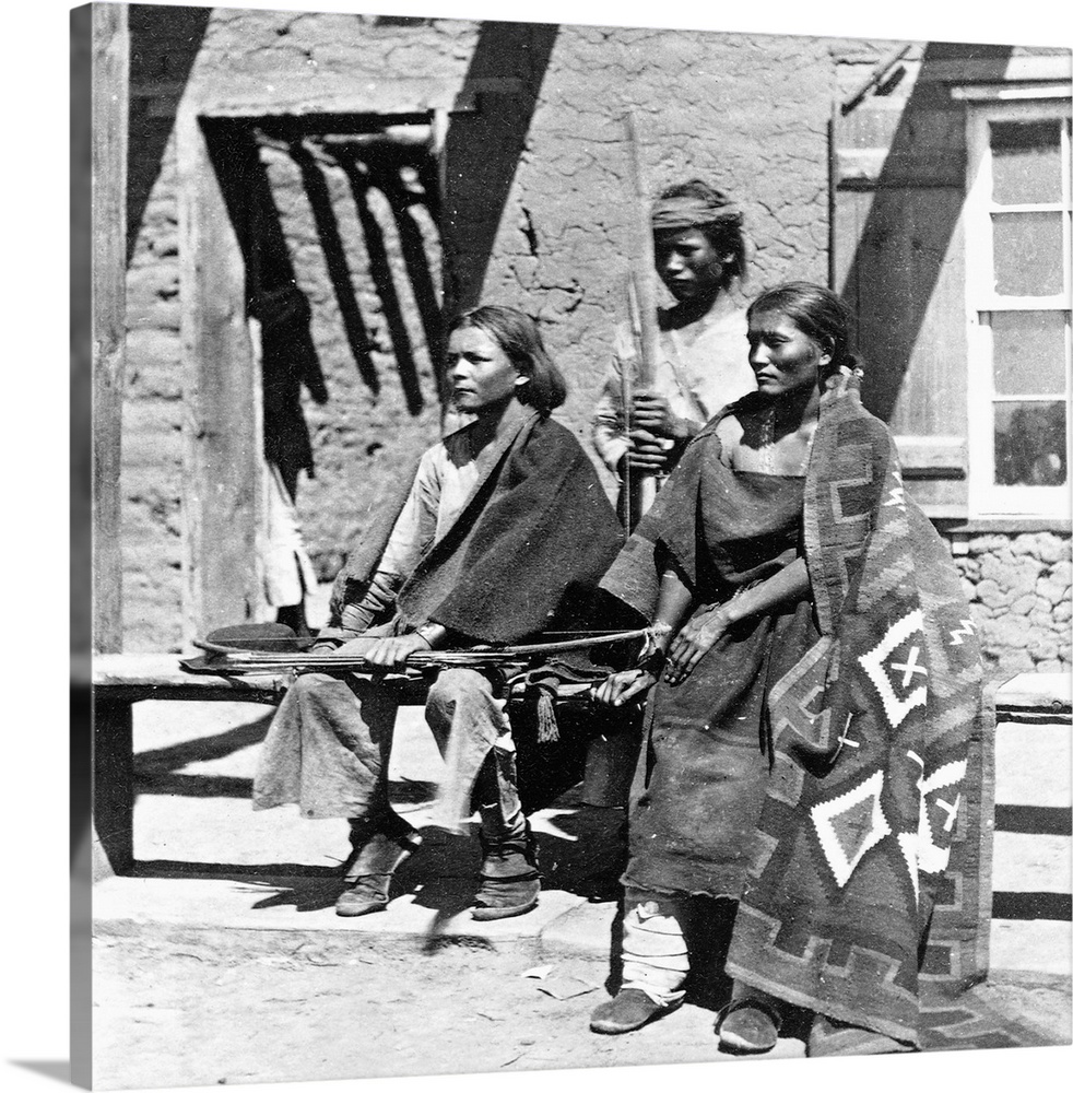 A Navajo woman and two young men in Old Fort Defiance in 1873, which was then used as a headquarters for the Agency in cha...