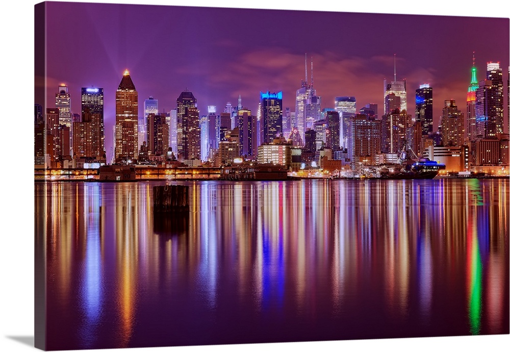 New York City (NYC) skyline looking East from New Jersey across the Hudson River at night with the Empire State Building i...