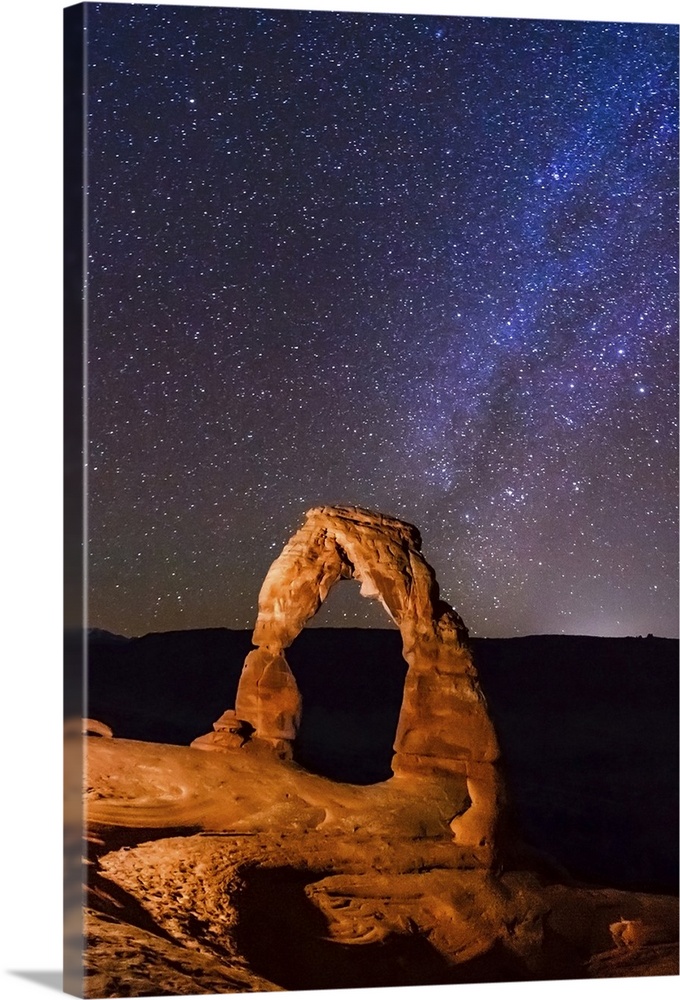 Night view of delicate arch and stars and Milky Way in southern sky, Arches National Park, Moab, Utah, United States.