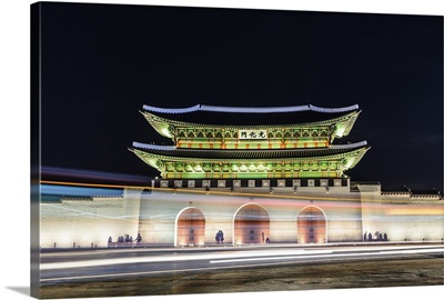 Night view of Gyeongbokgung palace with lights trails on road in Seoul, South Korea.