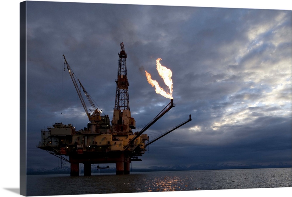 USA, Alaska, Natural gas flare from offshore oil drilling rig in Cook Inlet on summer evening