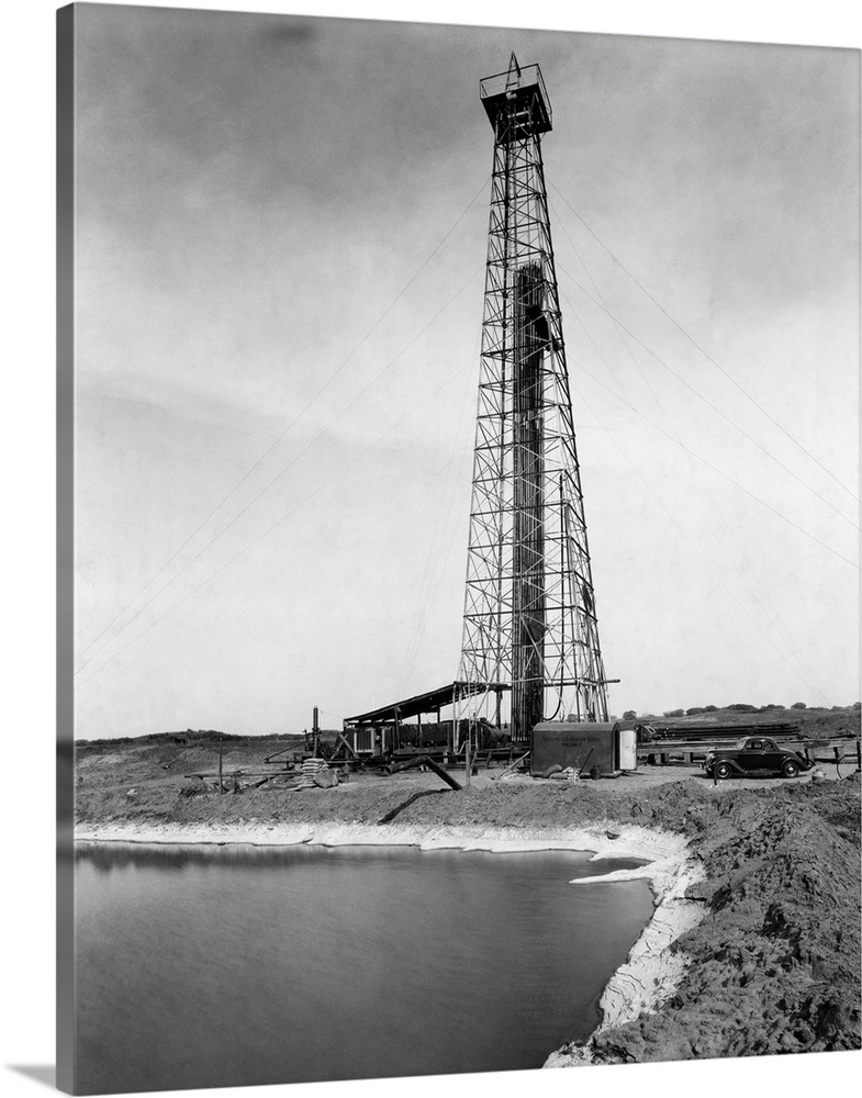 Hutchinson, KS: Drilling oil well with a tractor-operated rotary drill at Ellenwood (?), Kansas.