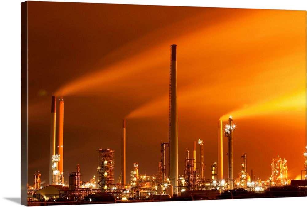 Netherlands Antilles, Curacao, Smoke and air pollution billow from glowing Venezuela-owned Isla Oil Refinery at night.