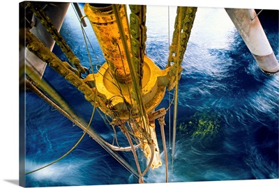 Oil rig drilling pipe at surface of water