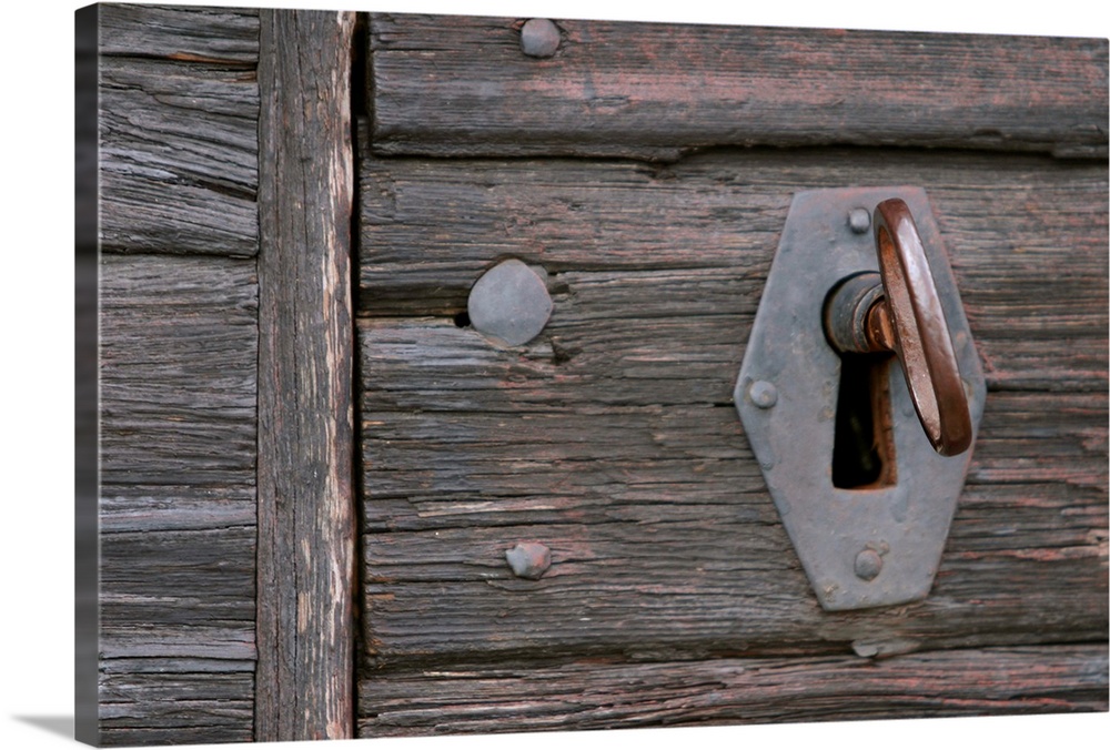 Old-fashioned lock and key in weathered wood