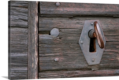 Old-fashioned lock and key in weathered wood