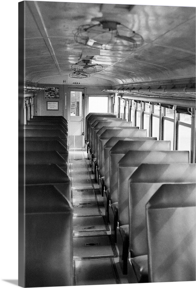 Black and white image of old passenger car of train.