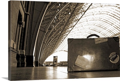 Old suitcase at St Pancras station in sepia