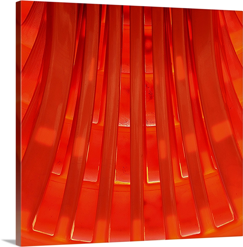 Graphic sunny view of a geometrical pattern made of orange molded plastic.